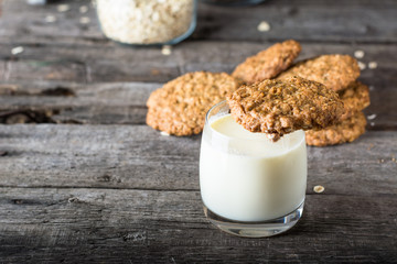 Homemade oatmeal cookies on wooden board on old table background. Healthy Food Snack Concept. Copy space. Milk and cookies. Still life of food. Christmas cookies. Healthy food. Breakfast concept.