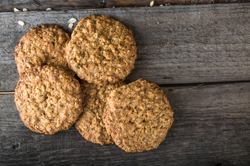 Homemade oatmeal cookies on wooden board on old table background. Healthy Food Snack Concept. Copy space. Milk and cookies. Still life of food. Christmas cookies. Healthy food. Breakfast concept.