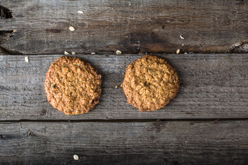 Homemade oatmeal cookies on wooden board on old table background. Healthy Food Snack Concept. Copy space. Milk and cookies. Still life of food. Christmas cookies. Healthy food. Breakfast concept.