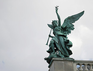 Statue of angel with trumpet and olive twig