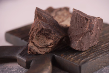 Slices of milk chocolate on a wooden surface