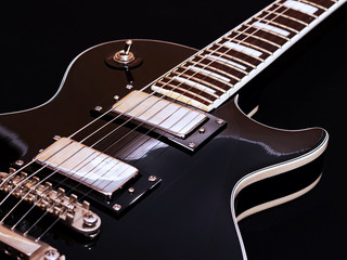 Fototapeta na wymiar Black electric guitar for background