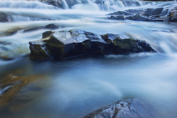 Big rocks in waterfalls of mountains river mountains. Water mountains landscape. Idea for outdoor activities, travel.