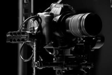 Sistem stabilization video camera and lens on steady equipment support such as gimbal steady or stabilized. Black background