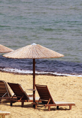 Sunbeds and reed umbrellas on the beach