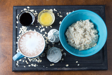 breakfast with porridge and coffee on a tray