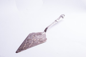 Beautiful and finely decorated silver cake knife isolated on white background