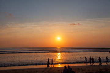 Naklejka na ściany i meble People enjoy sunset at Seminyak (Kuta) Bali - Indonesia