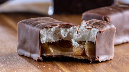 Chocolate candies on a wooden background. Close-up