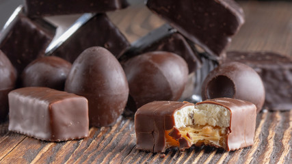 Chocolate candies on a wooden background. Close-up