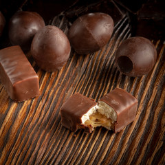 Chocolate candies on a wooden background. Close-up