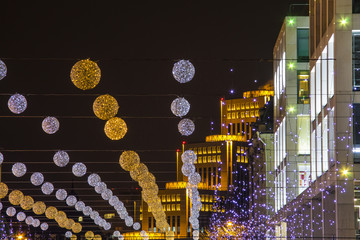 Festive night illumination, balloons and lights against the backdrop of beautiful modern buildings with lighting in the Ukrainian city of Dnipro, Dnepropetrovsk, Ukraine. (Dnipro, Dnipropetrovsk).
