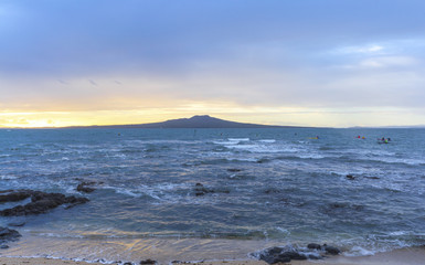 Landscape Scenery during Sunrise Time at Takapuna Beach, Auckland New Zealand; View to Rangitoto Island; Rough Seas
