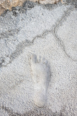 Shape of the foot in the old cement floor