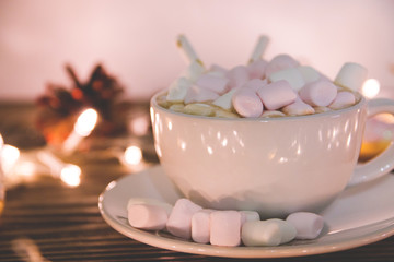 hot chocolate with marshmallow candy and Christmas decorations on a wooden background