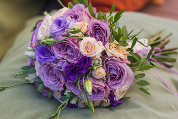 wedding bouquet on a green cushion, bouquet of bride from rose cream spray, rose bush, rose purple Memory Lane, violet eustoma, eucalyptus