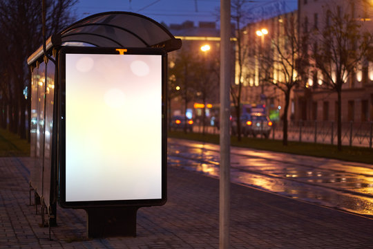 Train Stop Bus Shelter, With Advertising Billboard Light Advertisement For Advertising. Outdoor Advertising Luminous In The Night City. Layout For Advertising. Empty White Field. Bus Stop