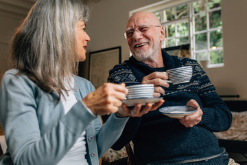 Senior couple enjoying coffee at home