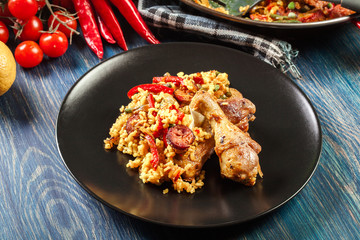 Traditional paella with chicken legs, sausage chorizo and vegeta
