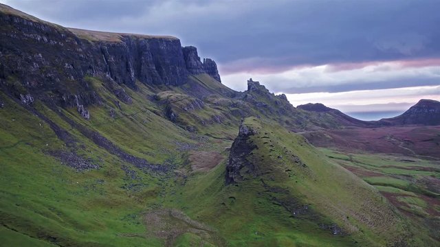 Cinematic flight over the Quiraing during sunrise on the eastern face of Meall na Suiramach, Isle of Skye, Highland, Scotland, UK