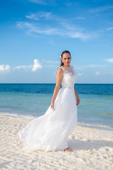 Fototapeta na wymiar Beautiful mature bride in a tropical beach