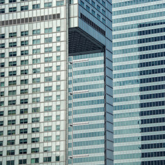 Obraz na płótnie Canvas Skyscraper. Modern architectural building. Glass and concrete. Urban landscape. City Business District. High-rise buildings. Close up