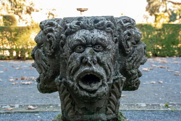 three faces head sculpture