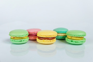 Sweet almond colorful pink, biue, yellow, green macaron or macaroon dessert cake isolated on white background. French sweet cookie. Minimal food bakery concept. Copy space
