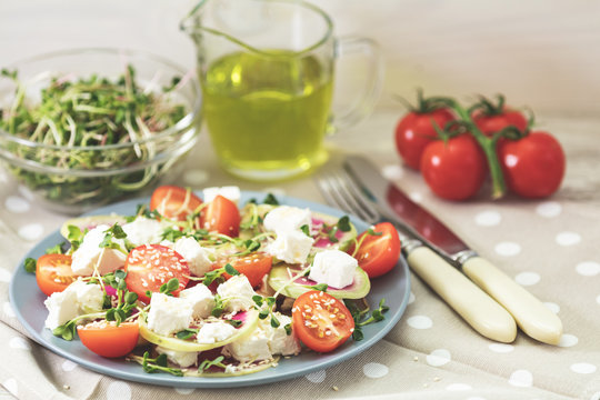 Healthy delicious tasty salad with tomatoes, radishes, cheeses, sprouts and sesame