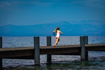 Girl running on dock