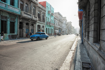 Typical street scene with people and colorful buildings. Havana is the capital of Cuba and the largest city in the Caribbean