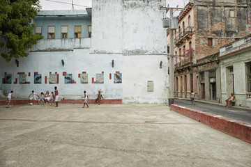 Unidentified young men playing soccer in the streets of Havana. Havana, Cuba