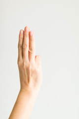 A hand sign with three fingers in scout meaning is swearing or salute.