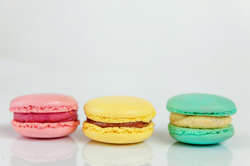 Sweet almond colorful pink, biue, yellow macaron or macaroon dessert cake isolated on white background. French sweet cookie. Minimal food bakery concept. Copy space