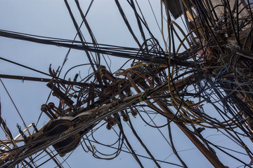 Wires attached to the electric pole, the chaos of cables and wires on an electric pole in New dehli, India, concept of electricity