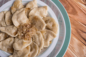 Traditional ukrainian or russian meal vareniki or dumplings with potato served with caramelized salted onion