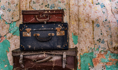 vintage old  luggage, grungy wall background