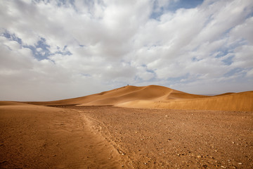 Fototapeta na wymiar Moroccan desert landscape with blue sky. Dunes background