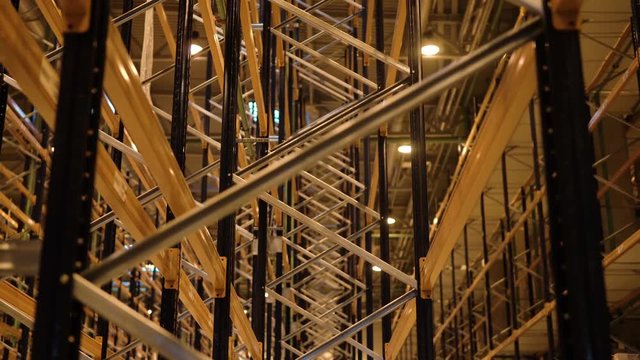 Empty shelves in distribution warehouse. Pallet racking system for warehouse storage. Metal shelving in distribution logistic center. Industrial engineering.