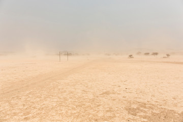 desert Soccer field in front of a white sand storm, Namibia, Africa