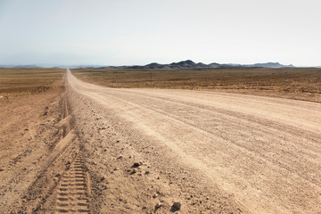 Fototapeta na wymiar Gravel road to the Fish River Canyon, south of Namibia, Africa. Dry season