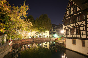 Fototapeta na wymiar Strasbourg,France-October 13, 2018: Houses along Ill river in Strasbourg, France, early in the morning
