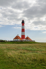Fototapeta na wymiar Westerheversand lighthouse surrounded by salt marshes, Eiderstedt, Germany