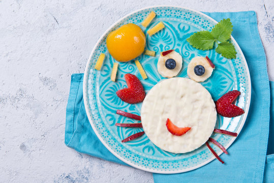 Sweet rice waffles with yogurt in the shape of a crab with fresh fruits, meal for kids idea, top view