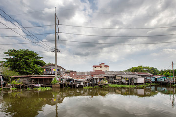Stilt houses at a klong in Bangkok. Klongs are the canals, that branch off from Chao Phraya river, the big river of Bangkok. The klong is the only way to get to these houses