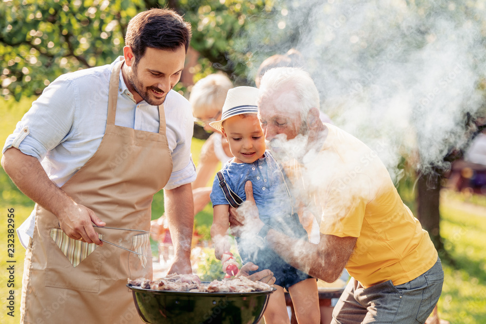 Canvas Prints happy family barbecuing meat on the grill