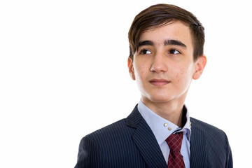 Studio shot of young handsome Persian teenage businessman thinki