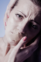 Mouth sealed shut as a symbol of strong pain and negative emotions, fear and  hopelessness.