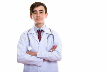 Fototapeta premium Studio shot of young handsome Persian teenage doctor with arms c