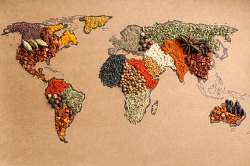 Paper with world map made of different aromatic spices as background, top view